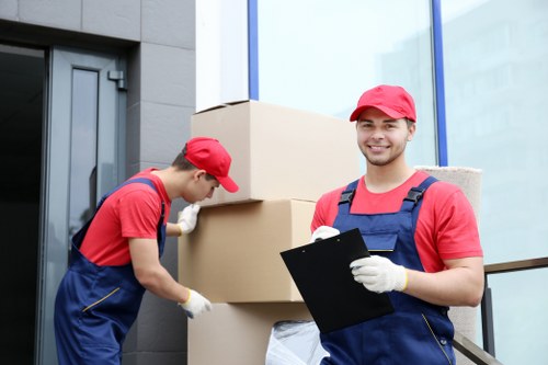 Professional moving team packing fragile belongings with care