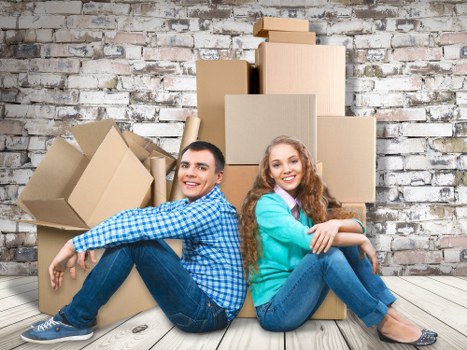 Professional movers handling desks and IT equipment during relocation