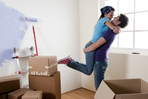 Professional movers handling desks and office items for a workplace move
