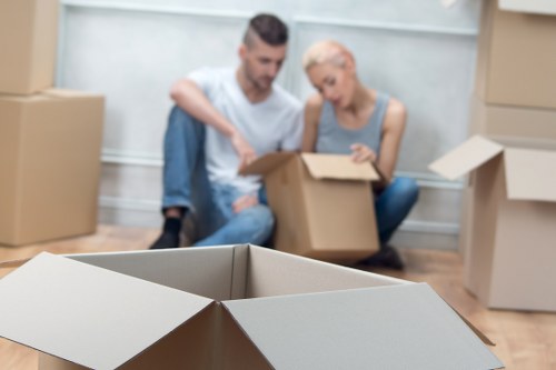 Careful unpacking of household items in a West Kensington home