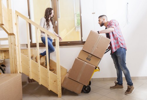 Mover handling a carefully wrapped item during relocation