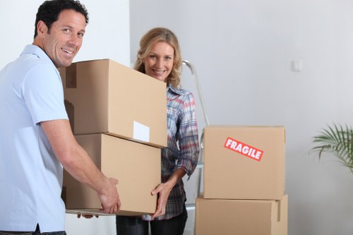 Professional movers carrying boxes during an urgent West Kensington move
