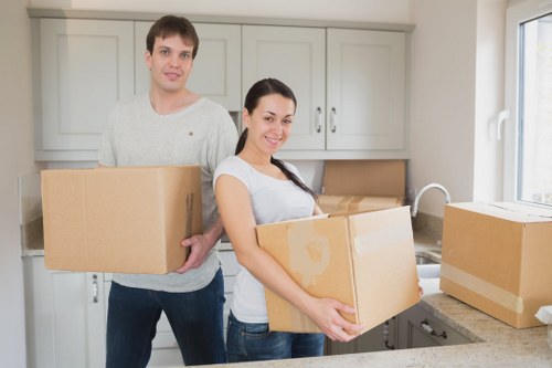 Professional movers packing fragile household items
